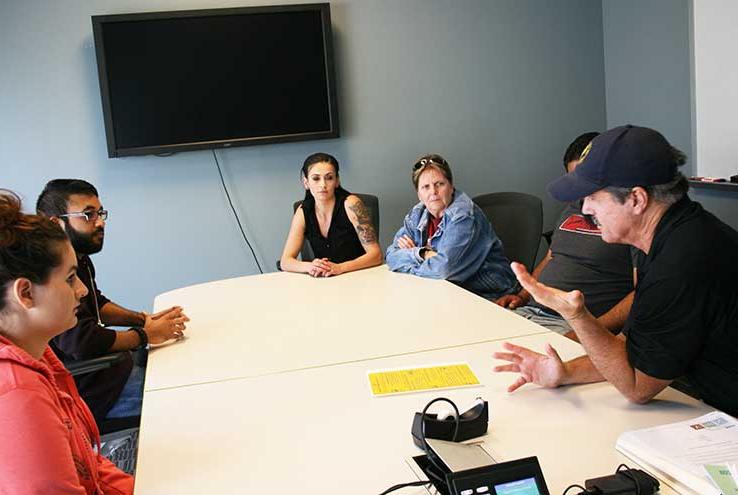 Students and staff in a support group discussion